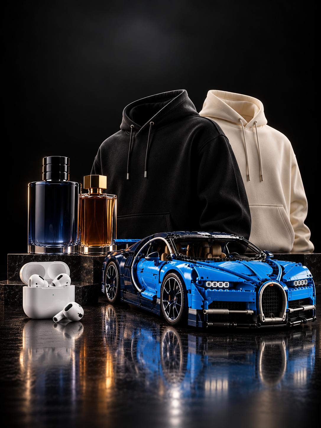 Perfume bottles, black and cream hoodies, wireless earbuds and a blue building-set supercar on a dark reflective surface